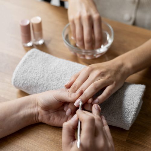 close-up-manicurist-holding-nail-tool